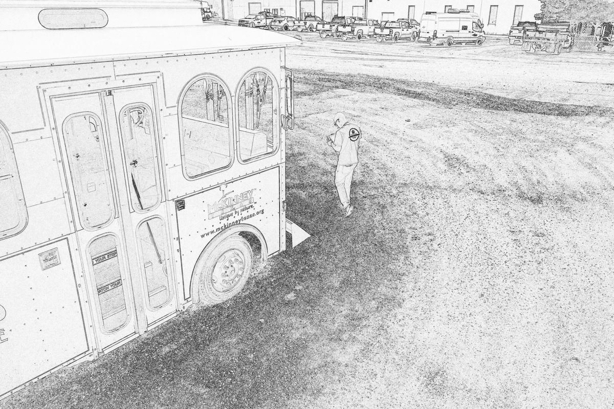 An animated gif of several photographs with a pencil-sketch filter showing a person walking in front of a trolley car